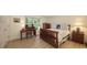 Well-lit bedroom with wood flooring, a bed with blue accents, a desk, and natural light at 1627 Peregrine Point Ct, Sarasota, FL 34231