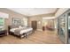Large Primary bedroom featuring wood floors and an adjoining sitting area at 1627 Peregrine Point Ct, Sarasota, FL 34231
