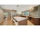 Modern kitchen with stainless steel appliances, a large center island, and mosaic tile backsplash at 1627 Peregrine Point Ct, Sarasota, FL 34231