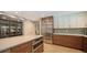 Spacious gourmet kitchen featuring stainless steel appliances, an island with a cooktop and wooden cabinets at 1627 Peregrine Point Ct, Sarasota, FL 34231