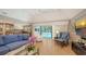 Bright living room with a vaulted ceiling, tile floors, and sliding glass doors to the pool at 1627 Peregrine Point Ct, Sarasota, FL 34231