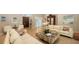 Airy living room with neutral walls, hardwood floors, modern furniture, and a view of the front yard at 1627 Peregrine Point Ct, Sarasota, FL 34231
