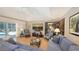 Open concept living room featuring a vaulted ceiling, tile floors, and views of the pool at 1627 Peregrine Point Ct, Sarasota, FL 34231