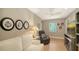 Cozy living room with a white sofa, a recliner, natural light, and decor at 1627 Peregrine Point Ct, Sarasota, FL 34231