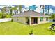Spacious backyard with lush green lawn, privacy fence, and covered patio at 1646 Pierpoint St, North Port, FL 34288
