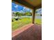 Outdoor patio area with brick flooring, well-manicured lawn, and white fence for privacy at 1646 Pierpoint St, North Port, FL 34288