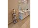 Well-lit bathroom boasts a double vanity, modern fixtures, and stylish towel storage rack at 1646 Pierpoint St, North Port, FL 34288