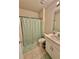 Clean bathroom featuring a shower with green patterned curtain and a vanity with sink at 1646 Pierpoint St, North Port, FL 34288