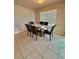 Inviting dining room features a modern table with seating for six and natural light at 1646 Pierpoint St, North Port, FL 34288