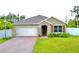 Charming one-story home features manicured lawn, brick driveway, and attached two-car garage at 1646 Pierpoint St, North Port, FL 34288