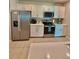 Bright kitchen features modern appliances, white cabinetry, and ample counter space at 1646 Pierpoint St, North Port, FL 34288