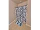 Clean shower area with blue floral shower curtain and tiled floor at 1646 Pierpoint St, North Port, FL 34288
