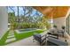 Inviting backyard space featuring a pool, outdoor seating, manicured lawn, and a wood ceiling at 1658 Bonita Ln, Sarasota, FL 34239