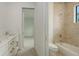 Beautiful bathroom showcasing a marble tiled shower and a white vanity with gold hardware and marble countertop at 1658 Bonita Ln, Sarasota, FL 34239