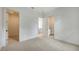 Bright and spacious bedroom with carpet flooring and multiple doorways to an additional room and ensuite bathroom at 1658 Bonita Ln, Sarasota, FL 34239