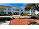Beautiful building with arched entryway, red tile roof, and manicured landscaping at 1658 Bonita Ln, Sarasota, FL 34239