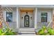 Beautiful home entrance featuring a decorative black door, wood ceiling, and stylish sconces at 1658 Bonita Ln, Sarasota, FL 34239