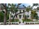 Stunning two-story home featuring lush landscaping, a black balcony, and a charming front entrance at 1658 Bonita Ln, Sarasota, FL 34239
