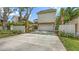 Exterior view features a stucco home with a spacious driveway, a two-car garage and manicured landscaping at 1658 Bonita Ln, Sarasota, FL 34239