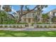 Stunning two-story home with a modern design, highlighted by lush landscaping, a walkway, and mature trees at 1658 Bonita Ln, Sarasota, FL 34239