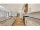 Contemporary kitchen featuring marble countertops, white cabinets, and a stylish range hood at 1658 Bonita Ln, Sarasota, FL 34239