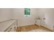 Bright laundry room with quartz countertops, shaker cabinets, hardwood floors, and natural light from a window at 1658 Bonita Ln, Sarasota, FL 34239
