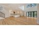 Bright and airy living room with hardwood floors, high ceilings, expansive windows, and an open-concept kitchen at 1658 Bonita Ln, Sarasota, FL 34239