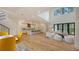 Bright living room with an open floor plan, chef's kitchen, expansive windows, and light hardwood floors at 1658 Bonita Ln, Sarasota, FL 34239