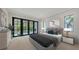 Serene main bedroom with large windows, a king-sized bed, and views of the backyard pool at 1658 Bonita Ln, Sarasota, FL 34239