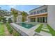 Backyard showcasing a modern pool design, lush green grass, and a beautiful home exterior at 1658 Bonita Ln, Sarasota, FL 34239