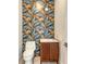 Chic powder room featuring a unique leaf-patterned wall, modern vanity, and stylish fixtures at 1658 Bonita Ln, Sarasota, FL 34239