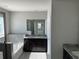 Bathroom featuring dual vanity with granite countertop, framed mirror, and separate tub at 17637 Cantarina Cv, Bradenton, FL 34211