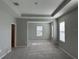 Bright bedroom with tray ceilings features neutral walls, plush carpeting, and natural light from windows at 17637 Cantarina Cv, Bradenton, FL 34211