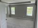 Spacious bedroom features neutral gray walls, plush carpeting, and natural light from three windows at 17637 Cantarina Cv, Bradenton, FL 34211