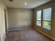 Cozy bedroom with plush carpeting and natural light from two large windows at 17637 Cantarina Cv, Bradenton, FL 34211