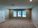 Spacious carpeted bedroom offering ample natural light through multiple windows at 17637 Cantarina Cv, Bradenton, FL 34211