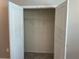 A closet with double doors and carpeted floors offers practical storage with a hanging rack at 17637 Cantarina Cv, Bradenton, FL 34211