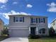 Charming two-story home with a well-manicured lawn, a two-car garage, and beautiful stone accents at 17637 Cantarina Cv, Bradenton, FL 34211