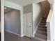 An interior view featuring a staircase with carpet leading to the second floor, with a conveniently placed closet at 17637 Cantarina Cv, Bradenton, FL 34211