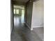 An interior view of a beautifully tiled entrance hallway leading to a spacious living area with large windows at 17637 Cantarina Cv, Bradenton, FL 34211