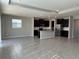 Spacious open-concept kitchen with dark cabinets, stainless steel appliances, granite countertops, and natural light at 17637 Cantarina Cv, Bradenton, FL 34211