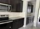 Kitchen featuring stainless steel appliances, dark cabinets, and a white subway tile backsplash at 17637 Cantarina Cv, Bradenton, FL 34211