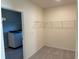 Functional laundry area with washer and dryer connections, with easy access shelving for storage at 17637 Cantarina Cv, Bradenton, FL 34211