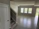 A staircase and tiled floor throughout the large living room, perfect for entertaining guests at 17637 Cantarina Cv, Bradenton, FL 34211