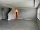 Open-concept living room with gray walls, tile flooring, and stairs leading to the second level at 17637 Cantarina Cv, Bradenton, FL 34211