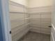 Walk-in pantry with metal shelving and tiled flooring for ample storage at 17637 Cantarina Cv, Bradenton, FL 34211