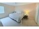 Bright bedroom with a large window, ceiling fan and neutral carpeting at 1959 Toucan Way # 206, Sarasota, FL 34232