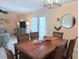 Cozy dining room features a wood table, seating for six, and a modern light fixture, perfect for Gathering meals at 1959 Toucan Way # 206, Sarasota, FL 34232