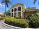 Beautiful community building with arched entryways and tropical landscaping at 1959 Toucan Way # 206, Sarasota, FL 34232