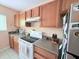 Well-lit kitchen with stainless steel appliances and ample counter space at 1959 Toucan Way # 206, Sarasota, FL 34232